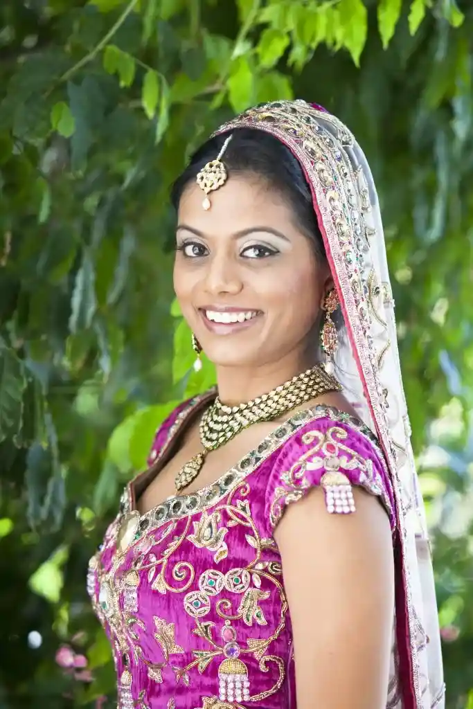 Bride in pink bridal outfit with traditional jewelry at destination wedding
